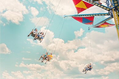 Mit Resilienz und Selbstwirksamkeit zu mehr Erfolg und Zufriedenheit Karusell in den Wolken. Sinnbild dafür das Gedankenkarussell zu durchbrechen.