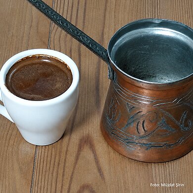 Kleine Metallkanne und kleine Tasse mit türkischem Mokka. 