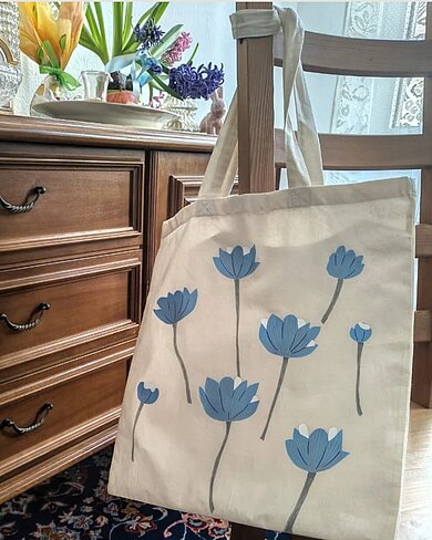 Stoffbeutel mit blauen Blumen.