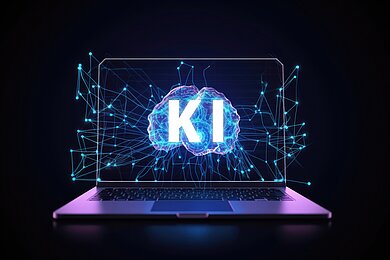 aufgeklappter Laptop mit der Aufschrift "KI"